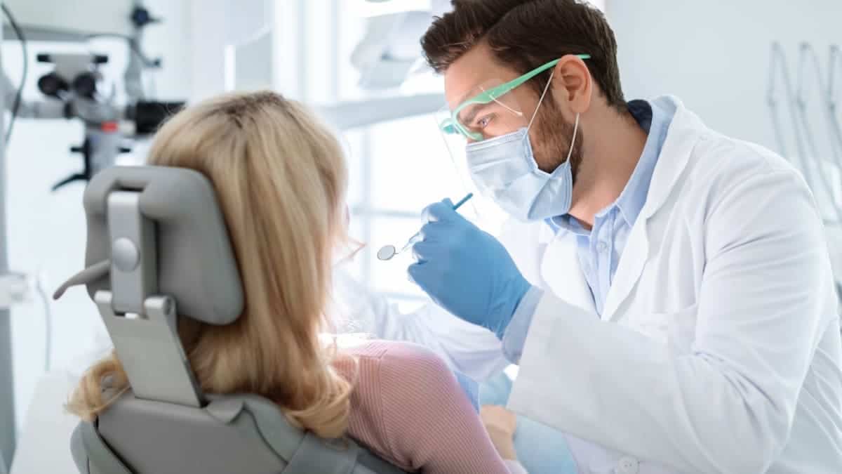 Patient receiving professional teeth whitening with a laser device Gloucester